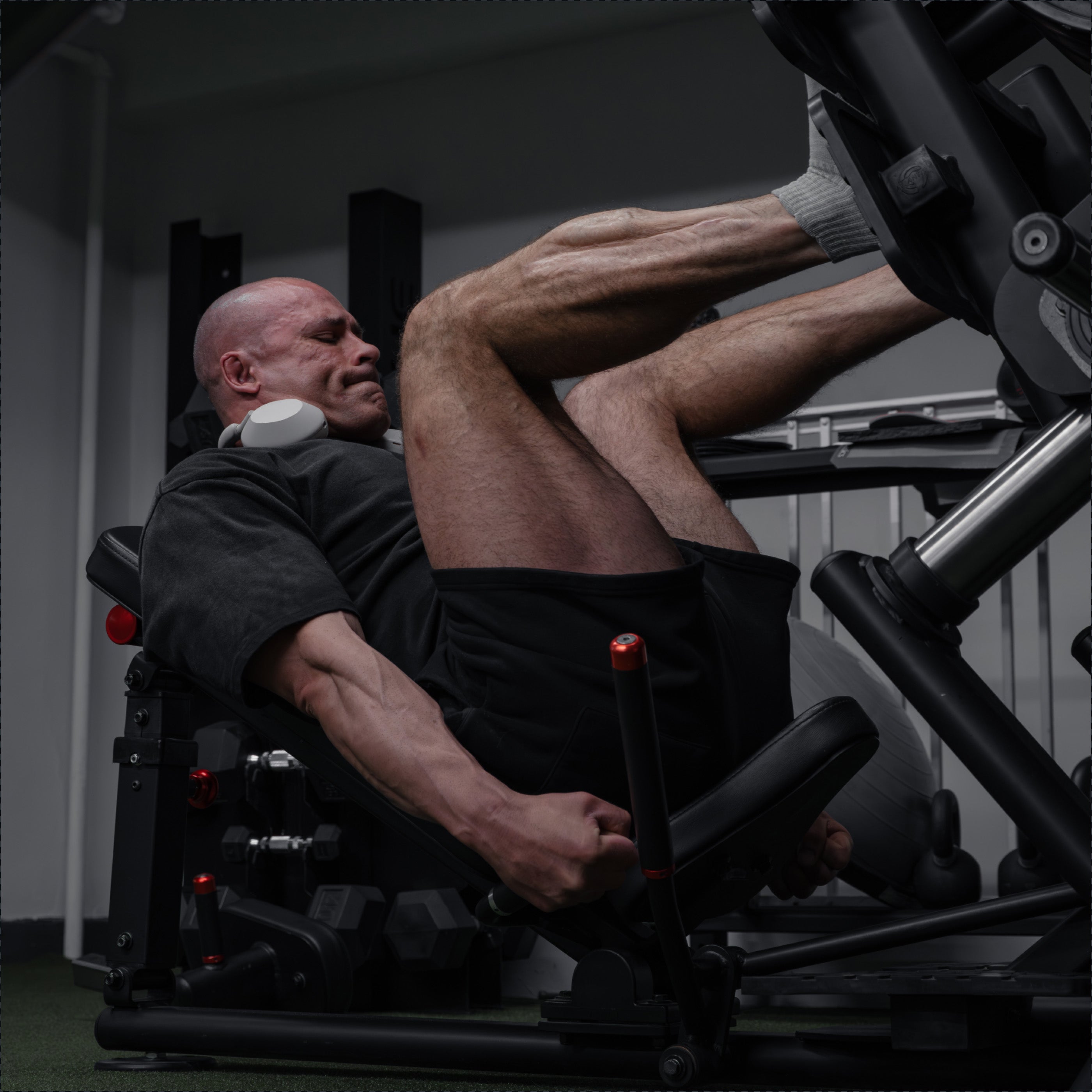 Athlete performing a lower-body press on a resistance machine