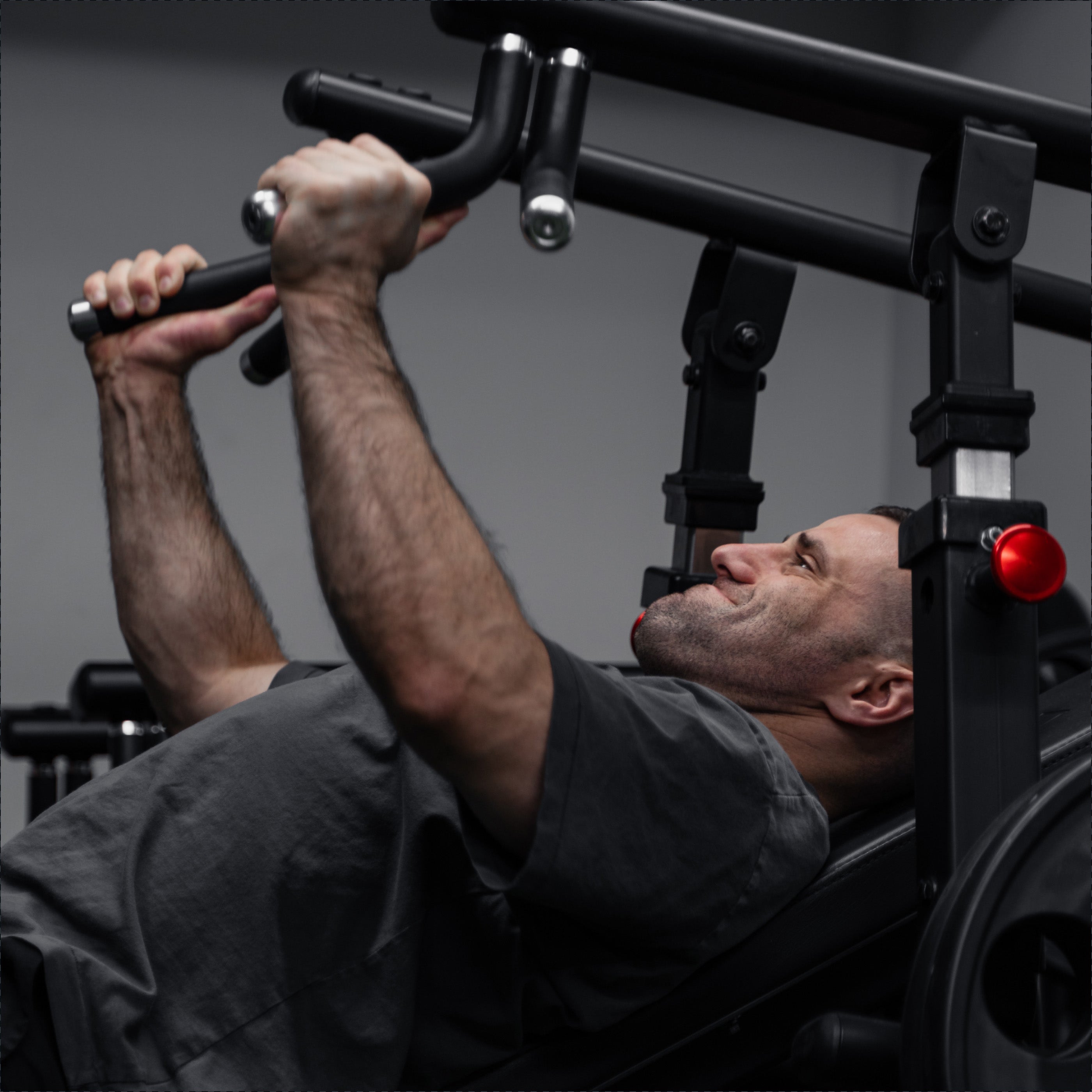 Athlete performing an upper-body press on a resistance machine